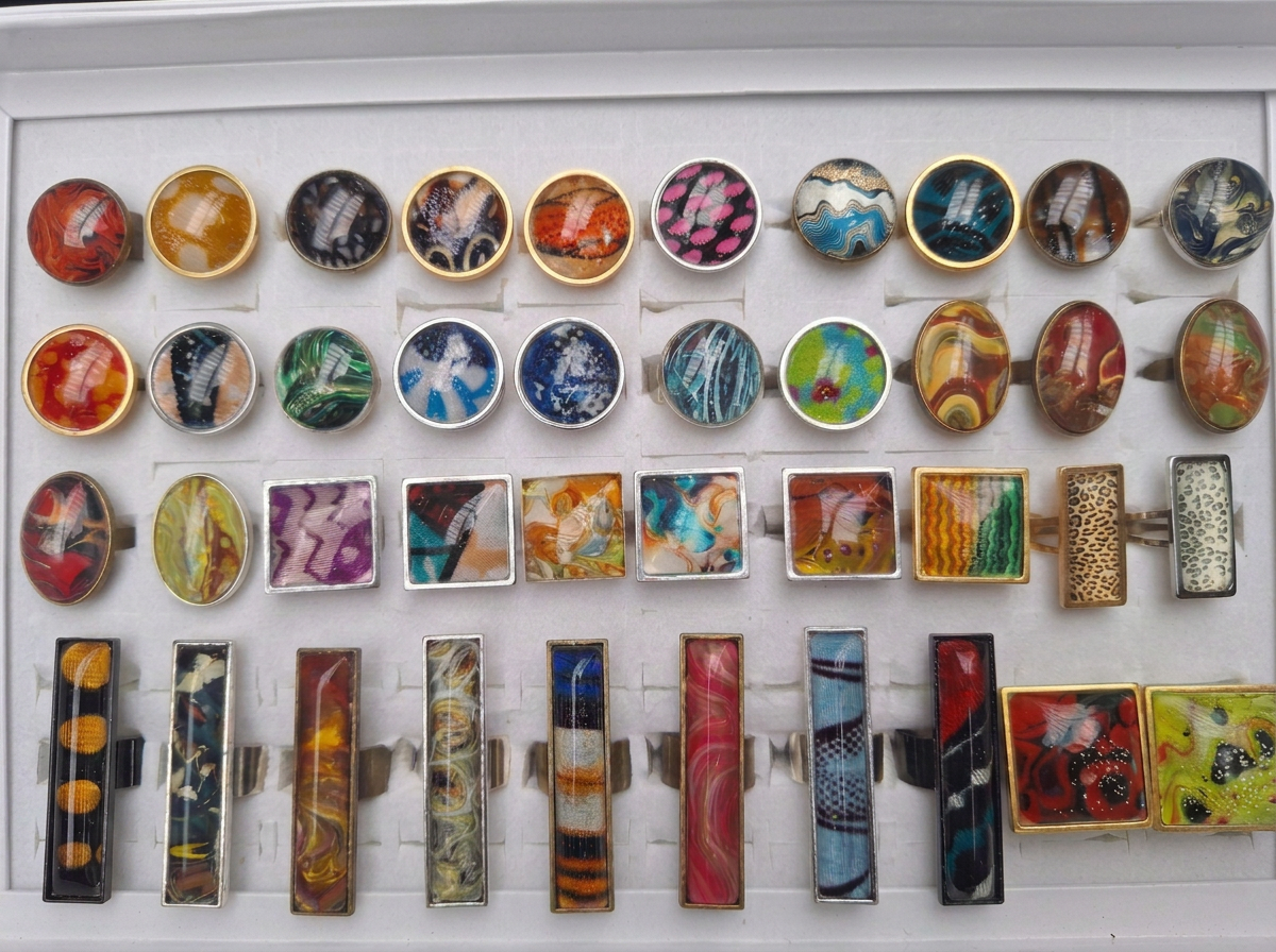 Colourful ring collection arranged in a display tray